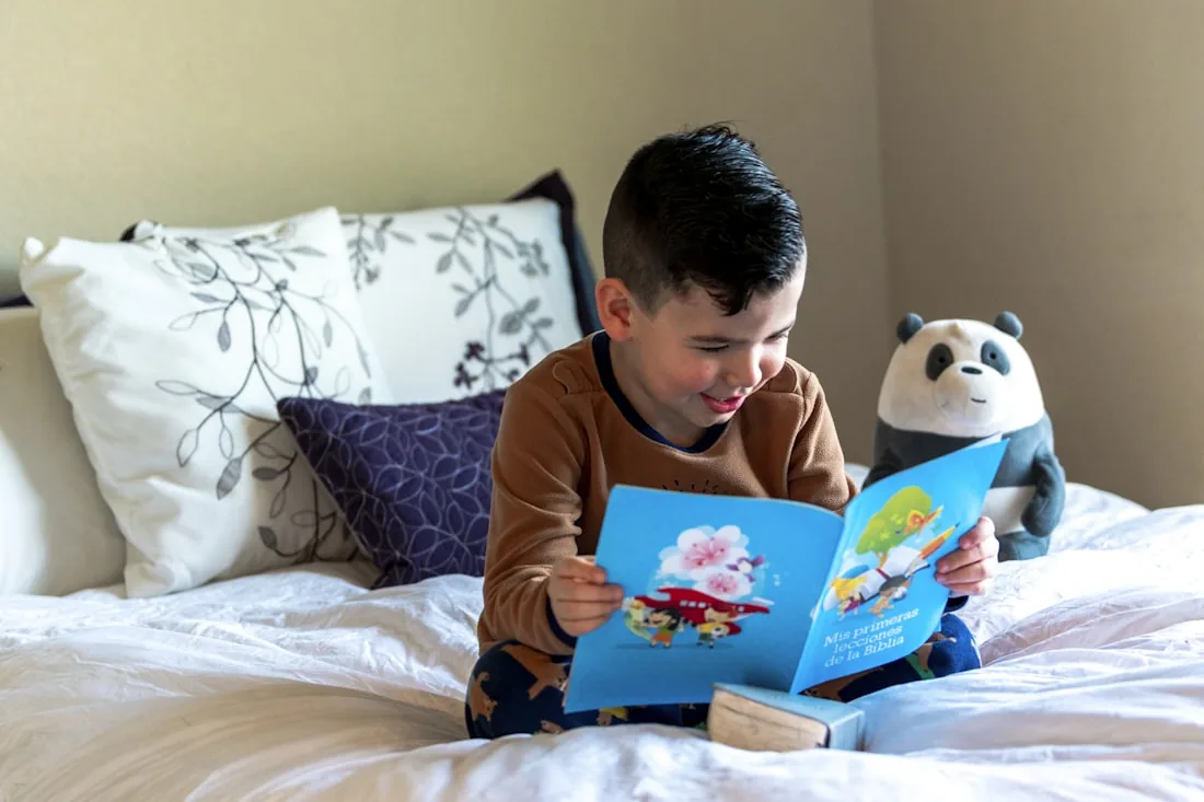 A child reading aloud from a book